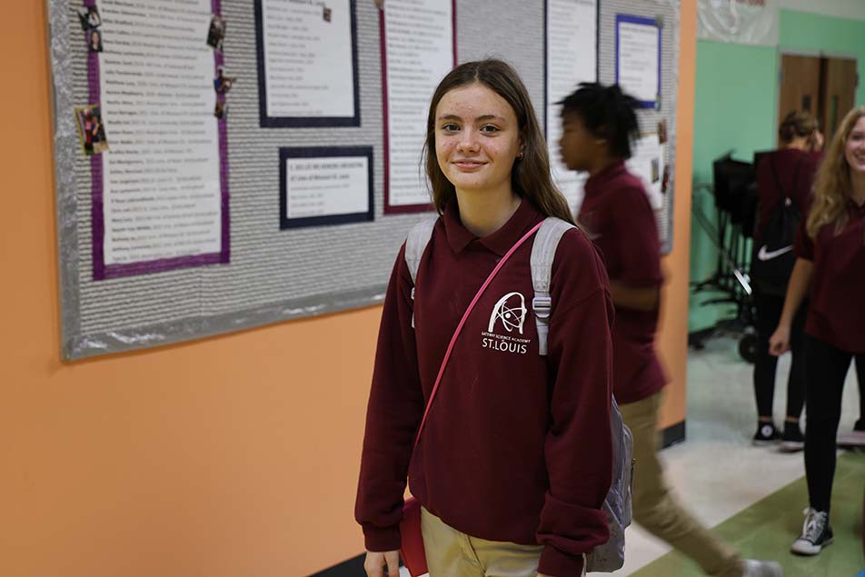 student in classroom smiling at camera